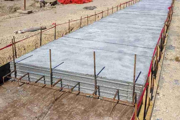 Reinforced concrete slabs under construction with steel framework and formwork in place.